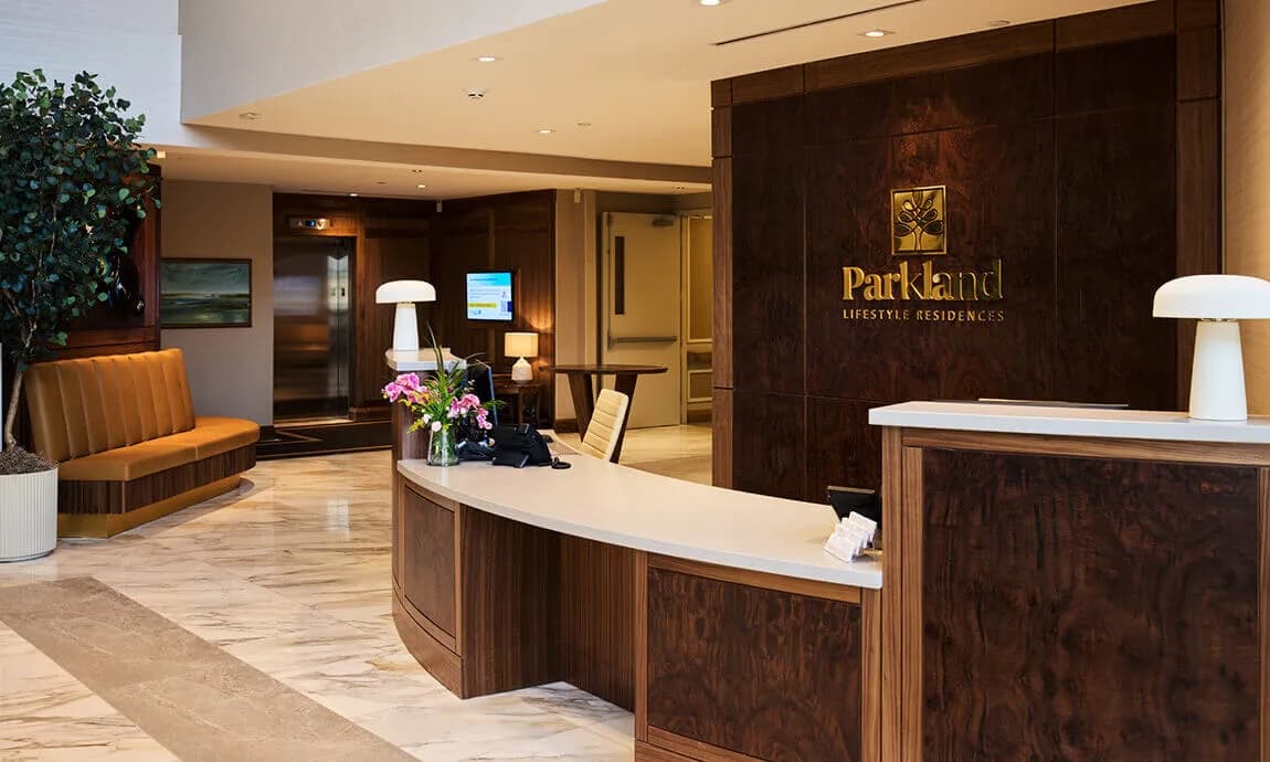 Curved reception desk and wood-paneled feature wall at Parkland Ancaster