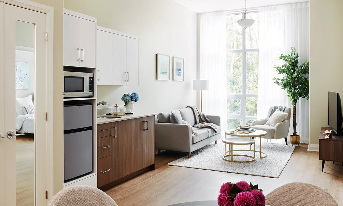 Suite living area with wood lower cabinets and white upper kitchen cabinets at Parkland Ancaster